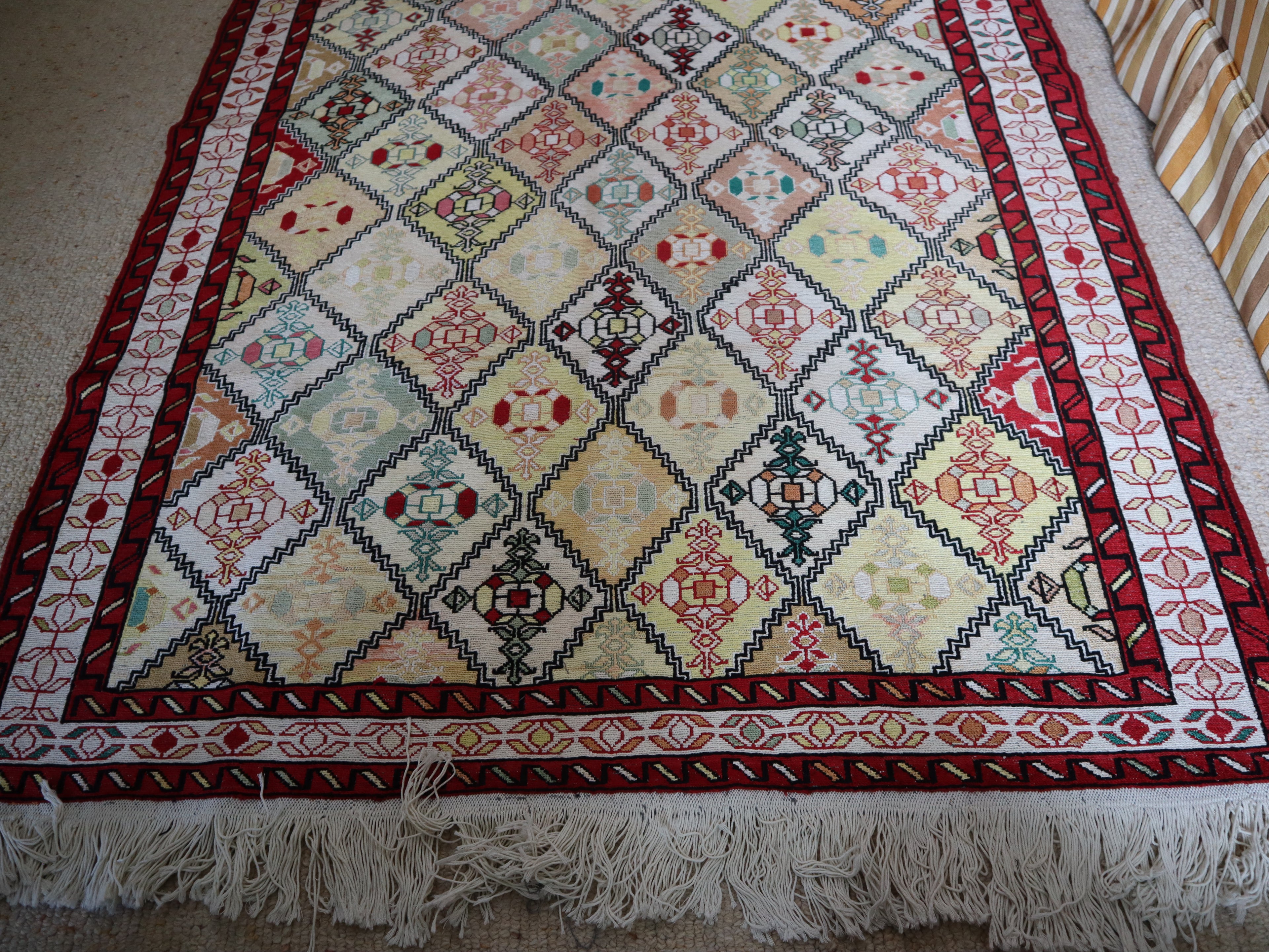 Angled view showing cotton fringe and full diamond field pattern