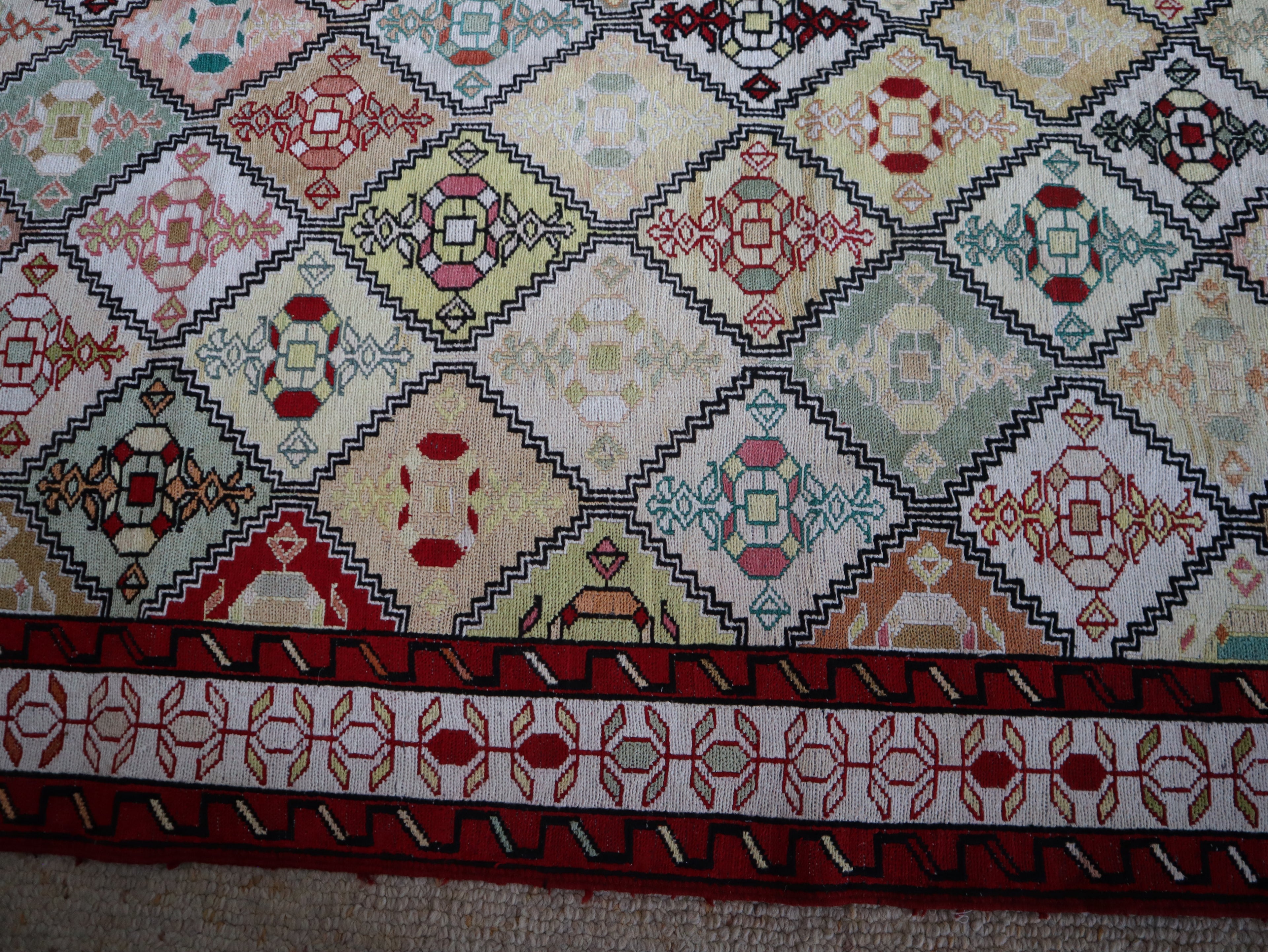 Close-up detail showing individual geometric motifs in naturally dyed silk