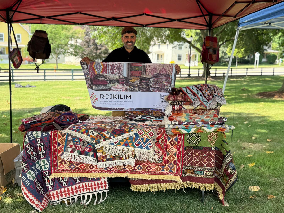 Azad, founder of RojKilim, sharing the handwoven collection at the Saline Jazz Festival in Michigan