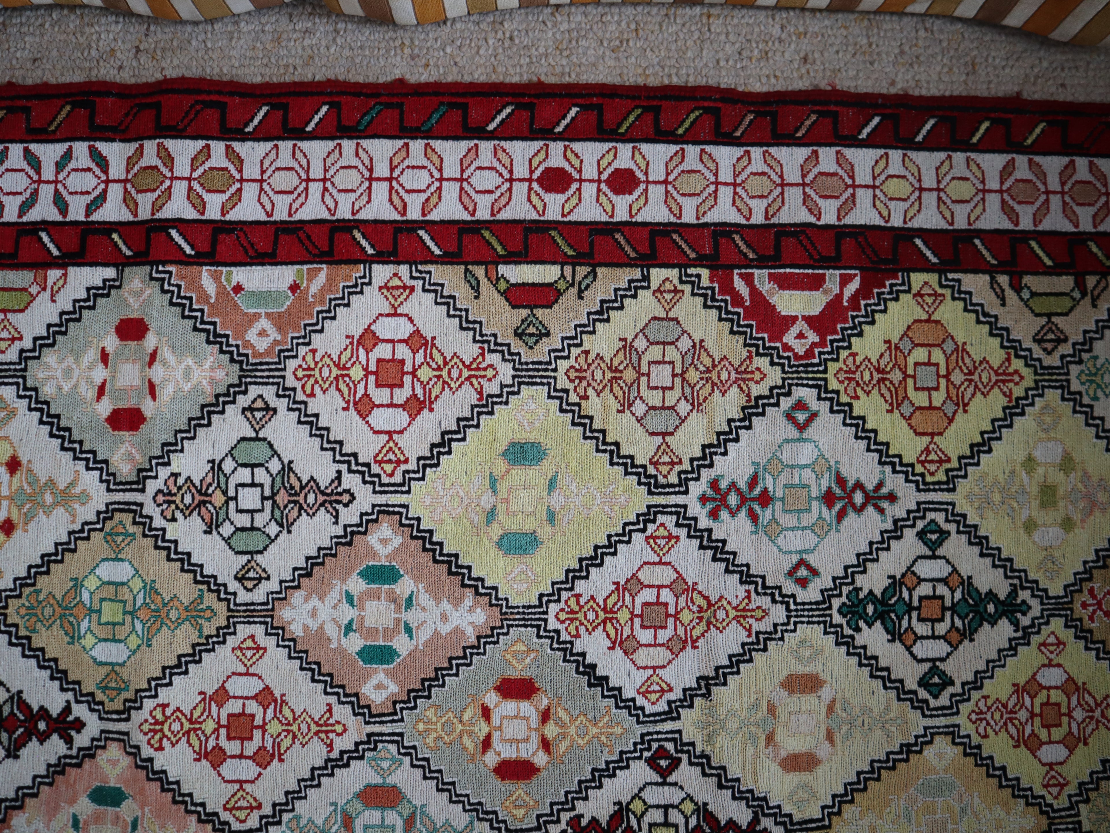 Close-up detail showing individual geometric motifs in naturally dyed silk